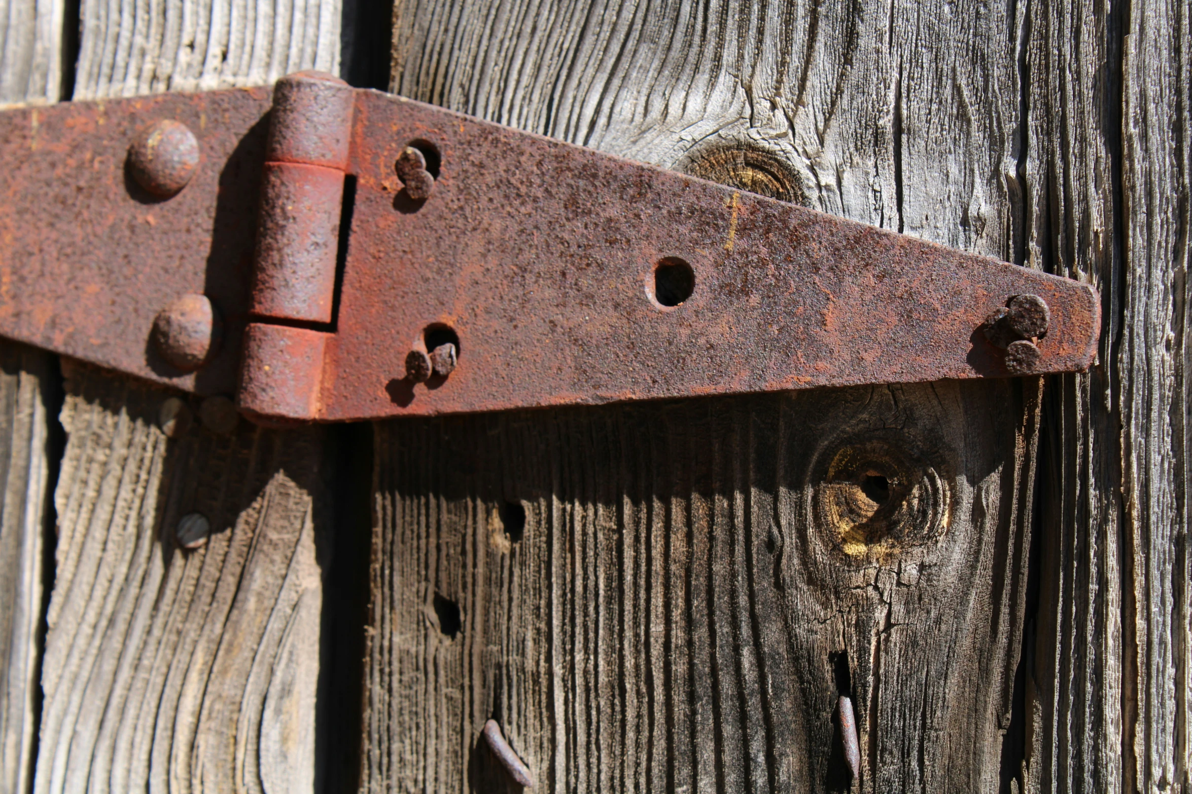 a metal lock on the side of a wooden wall