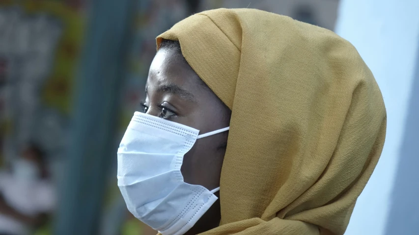 a woman wearing a face mask outside