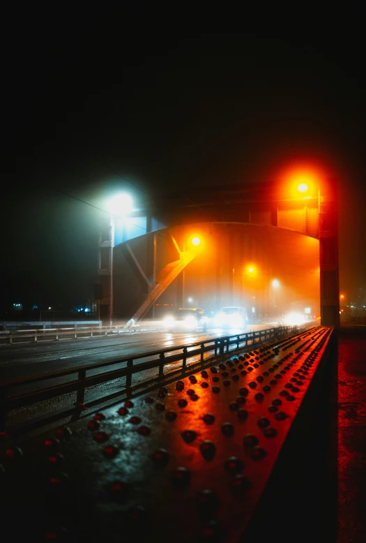 a road is on its side, with a foggy night and there's no traffic