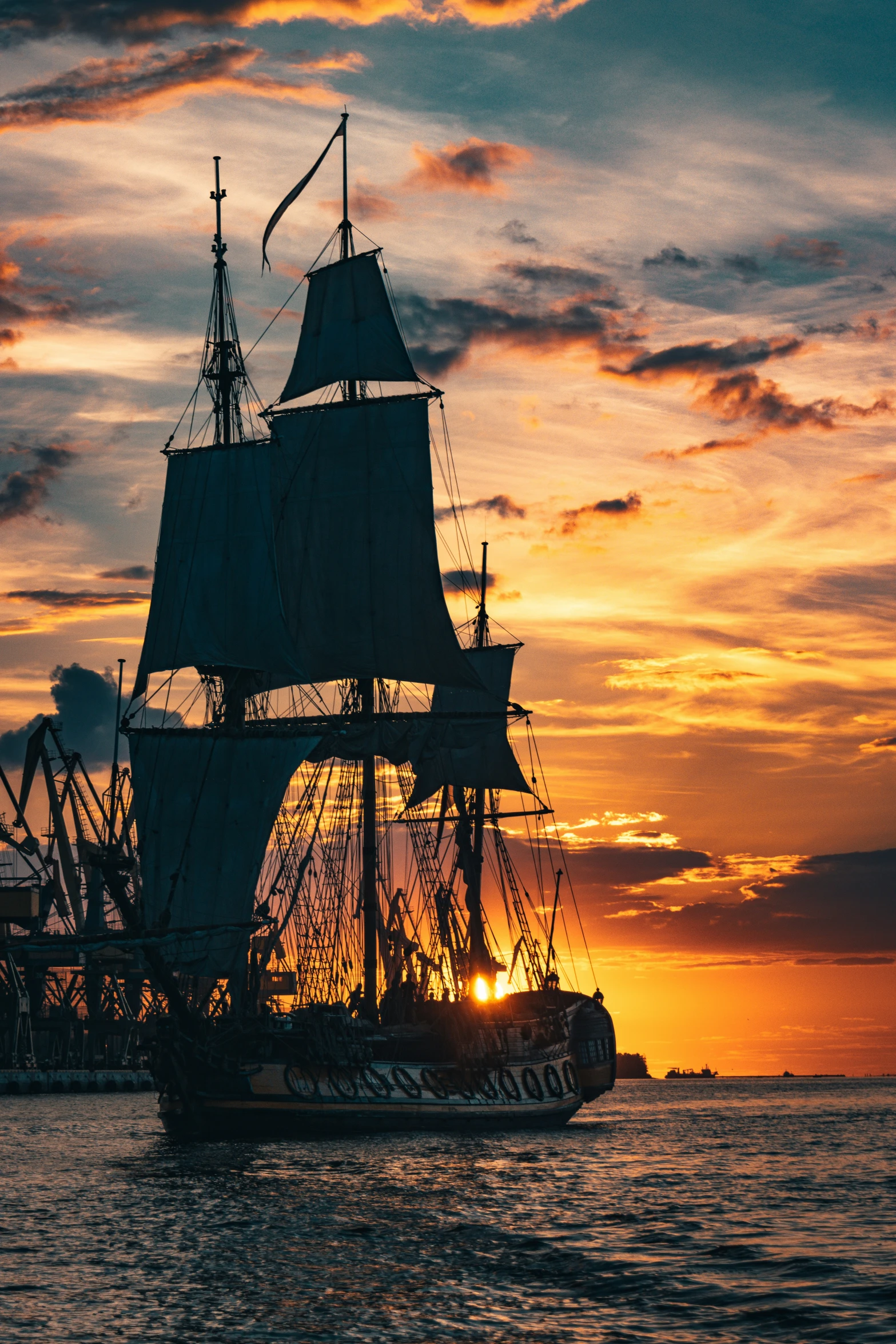 a large ship in the ocean at sunset