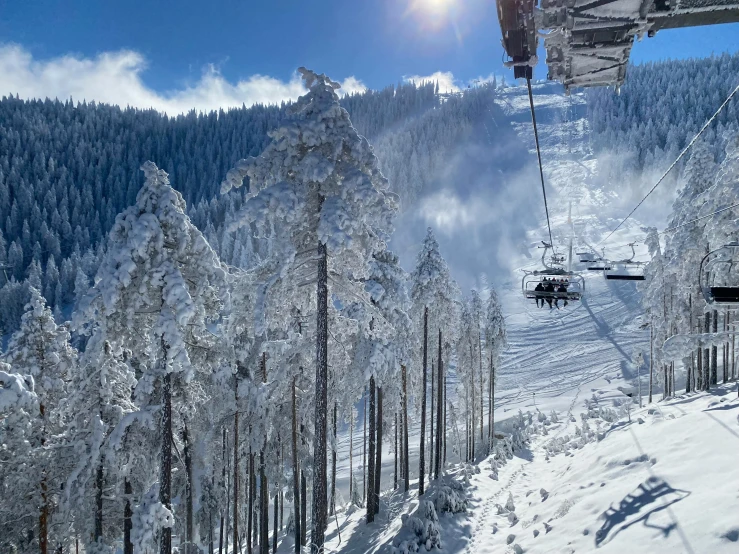 a cable car riding the top of a snow covered hill