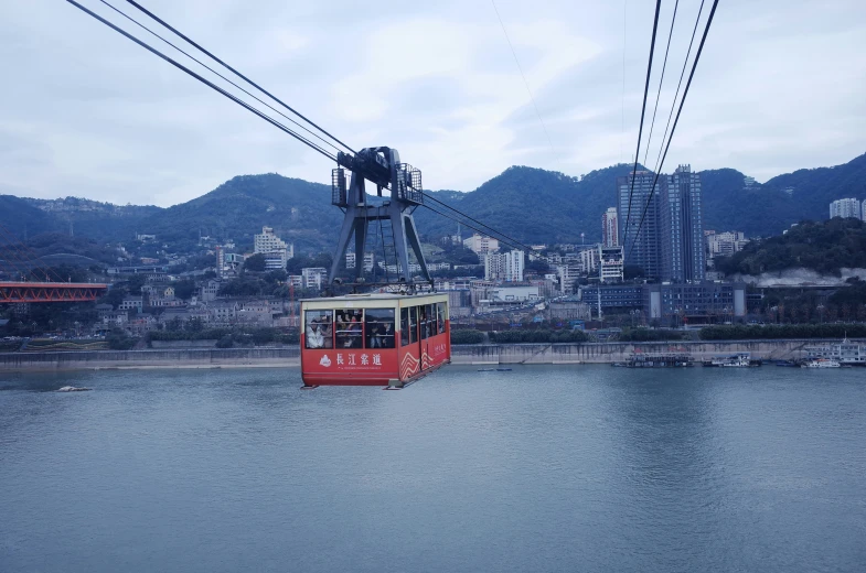 an image of a cable car going over the water