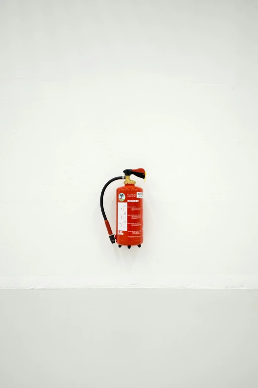 an empty fire extinguisher next to some white walls