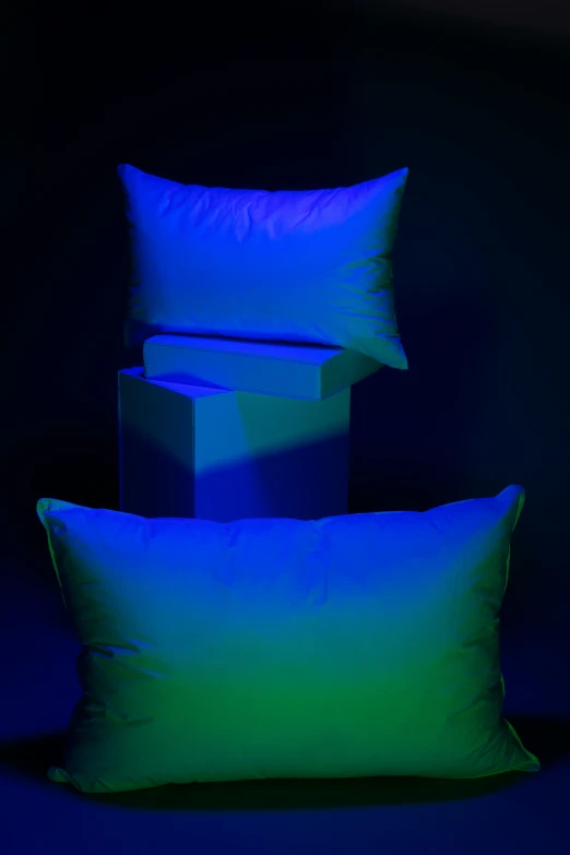 three pillows on a blue background