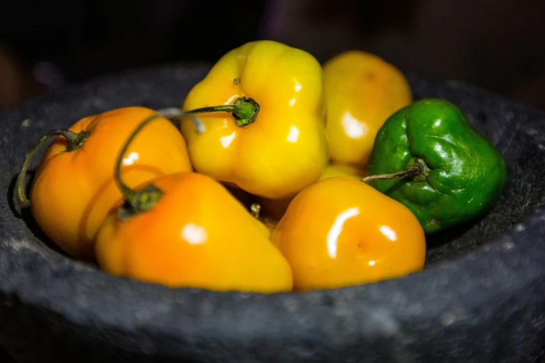 there are several different types of peppers in the bowl