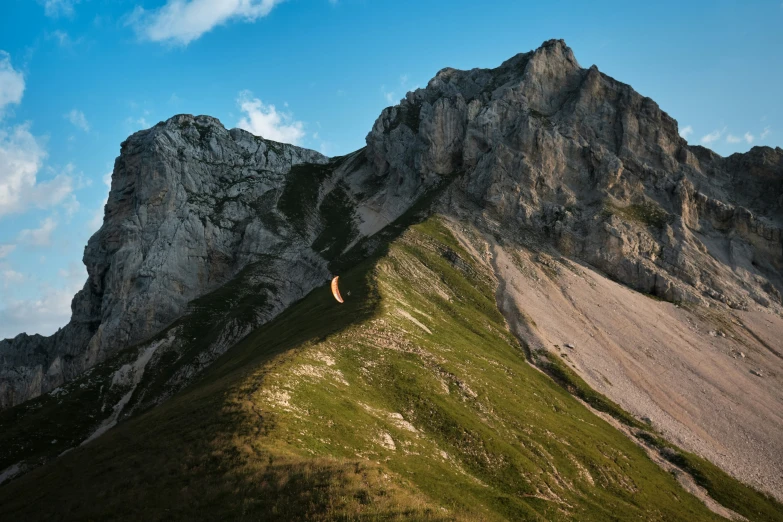 mountains are visible against the blue sky and clouds