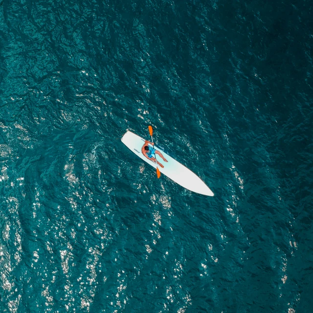 a surfboard in the middle of a body of water