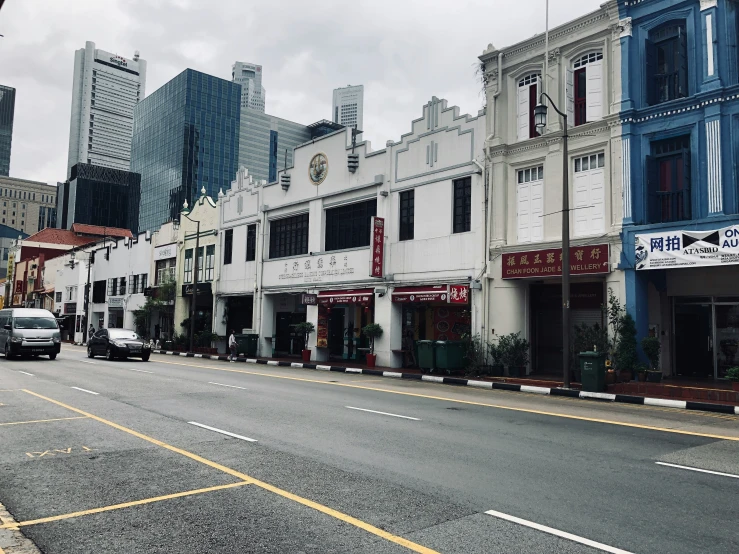 the city street has several buildings along side