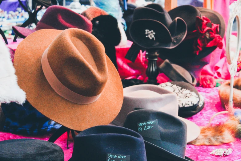 a variety of hats sitting on top of a table