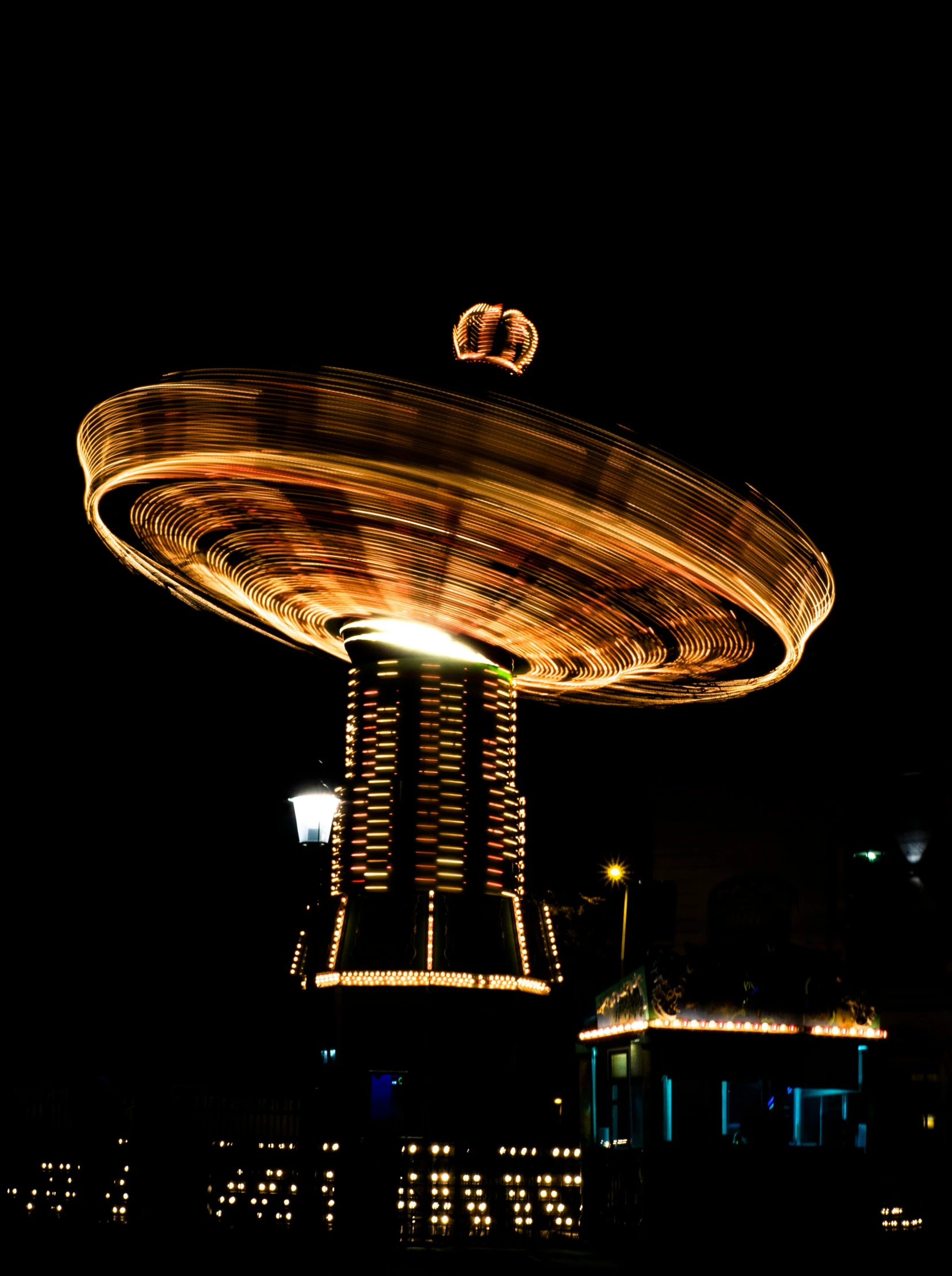 a carousel ride lit up in the night sky