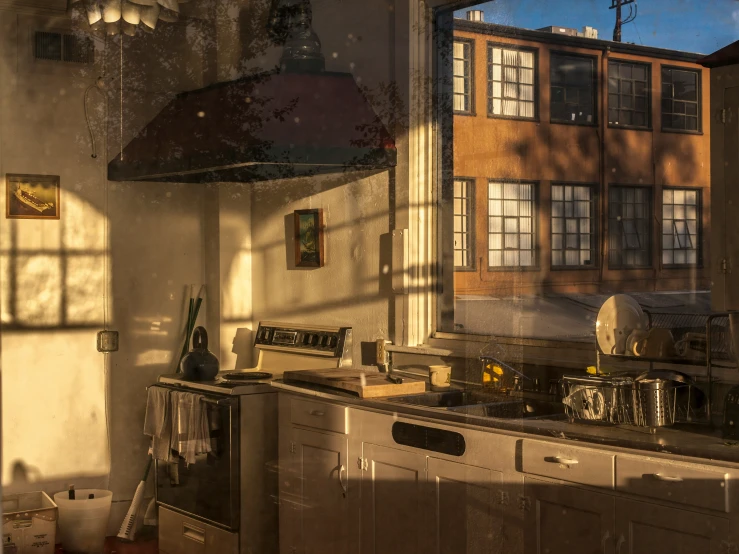 a view of kitchen with sunlight streaming through windows