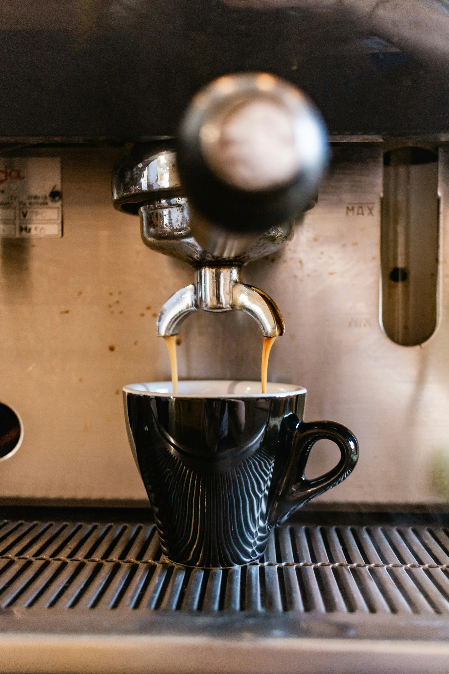 a coffee machine pours coffee into the cup