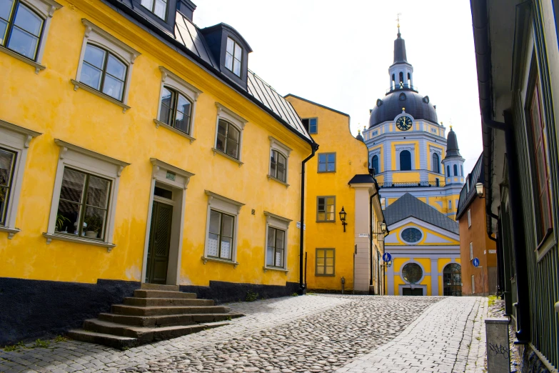 a clock tower and some yellow buildings