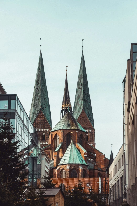 a building with spires and some buildings in the background