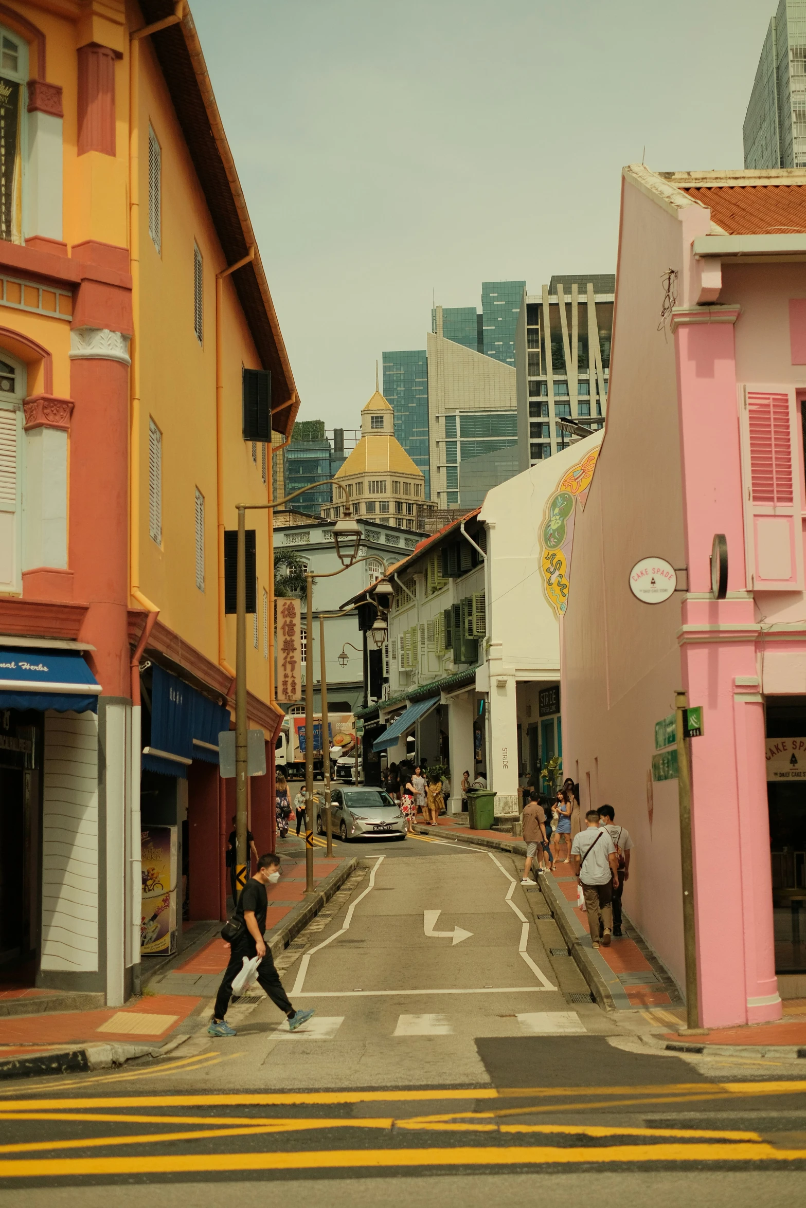 a person is crossing an empty street in a city