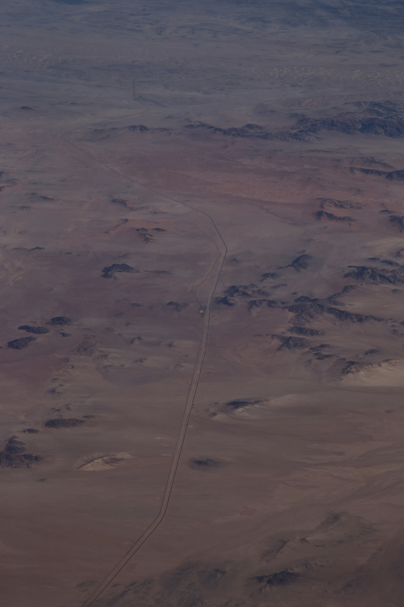 the view of an airplane's long track in the desert