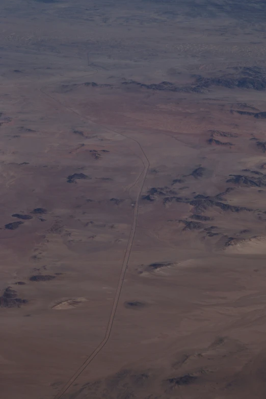 the view of an airplane's long track in the desert