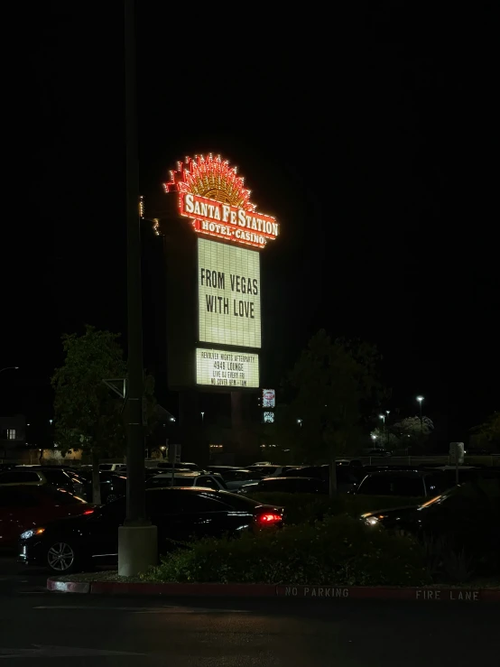 a large sign on the corner with lights coming out of it