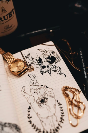 gold watches on notebook with pen and ink