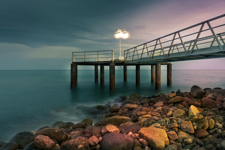 the lights shine bright on the beach with rocks and water