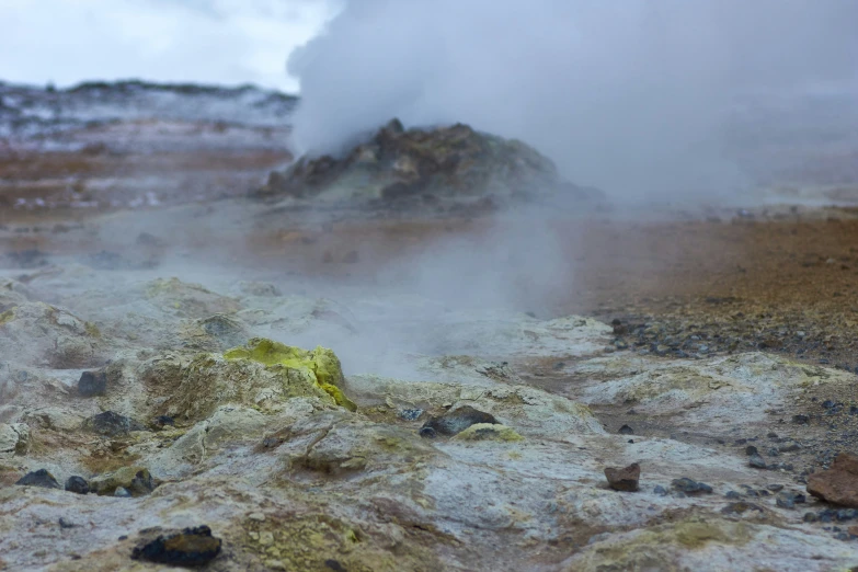 a large steamy geyser that is emitting some sort of fog