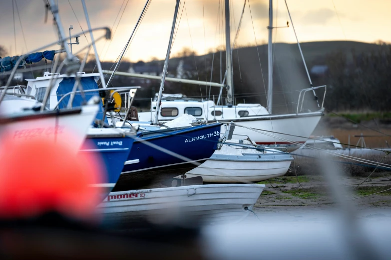 small sailboats sitting next to each other on the shore