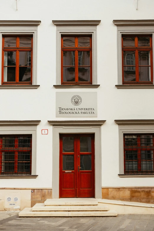 a building with two red doors and windows