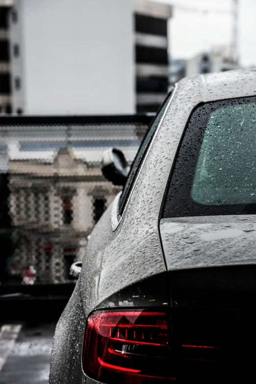 a black car parked on a wet street