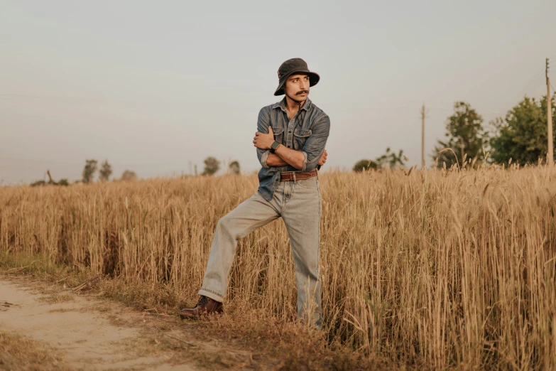 the man standing in front of a field of wheat