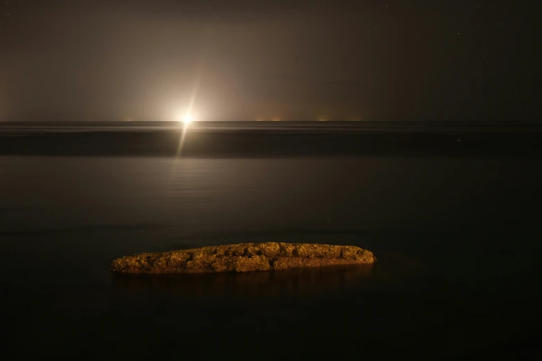 a small island in the middle of a lake at night