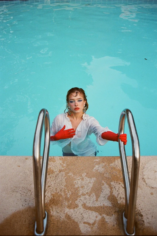 woman sitting in an empty swimming pool on her knees