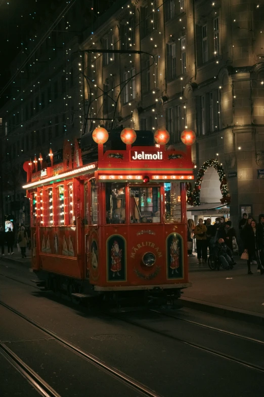 the trolley is driving through a city at night