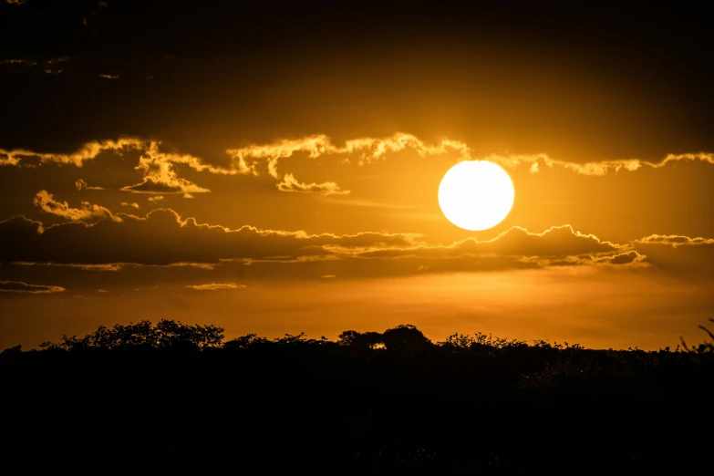 a dark cloudy sky with the sun shining brightly