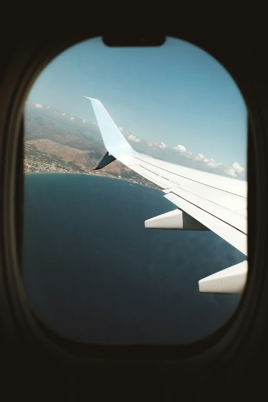 looking out an airplane window at the sea below