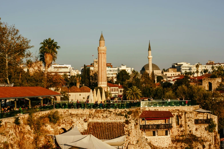 a city is seen with a church steeple and a minalis on the other side of the building