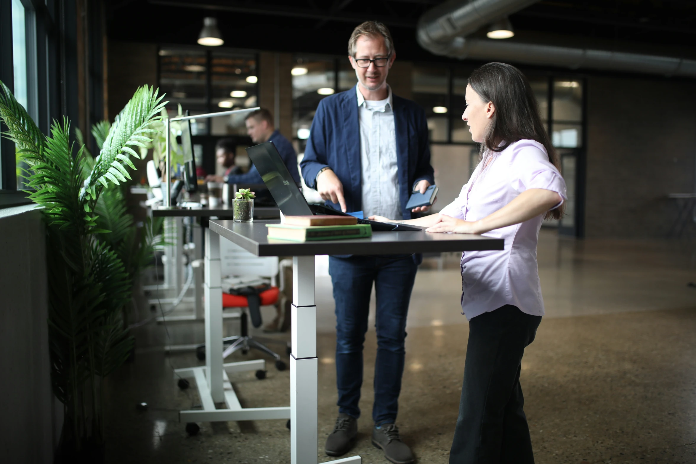 two people working at a computer in a clean building