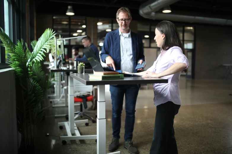 two people working at a computer in a clean building