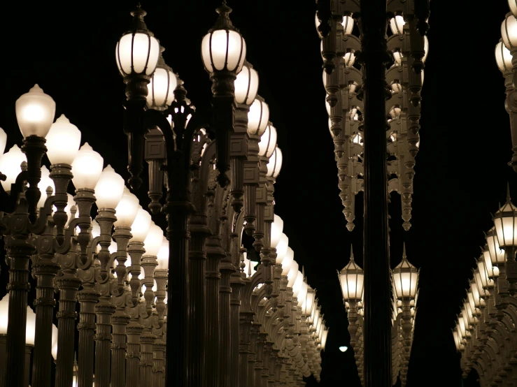 large group of lit up street lights on a city street