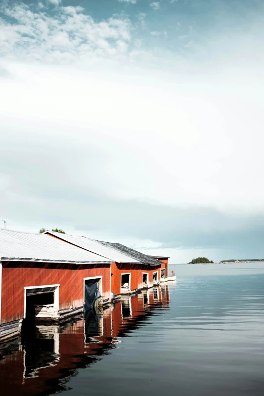 a red building is next to a small boat