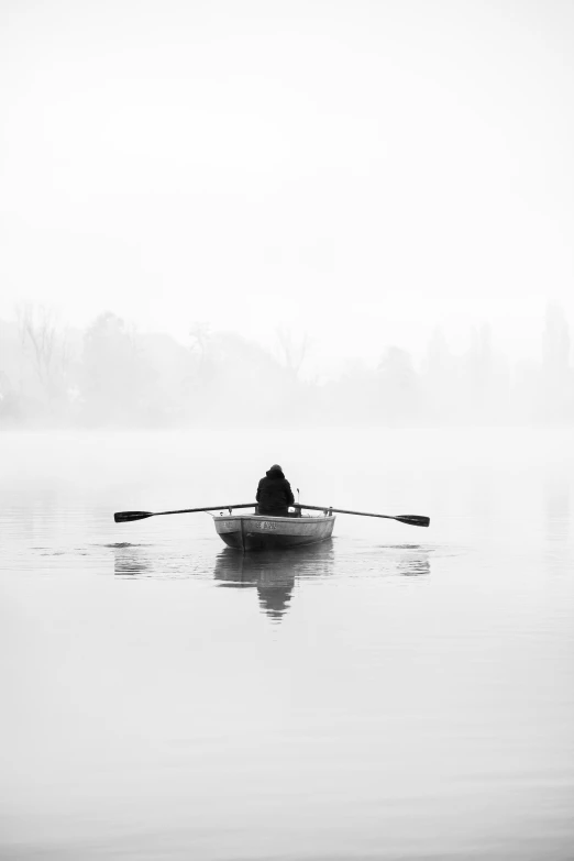 a person paddling on a small boat in the water