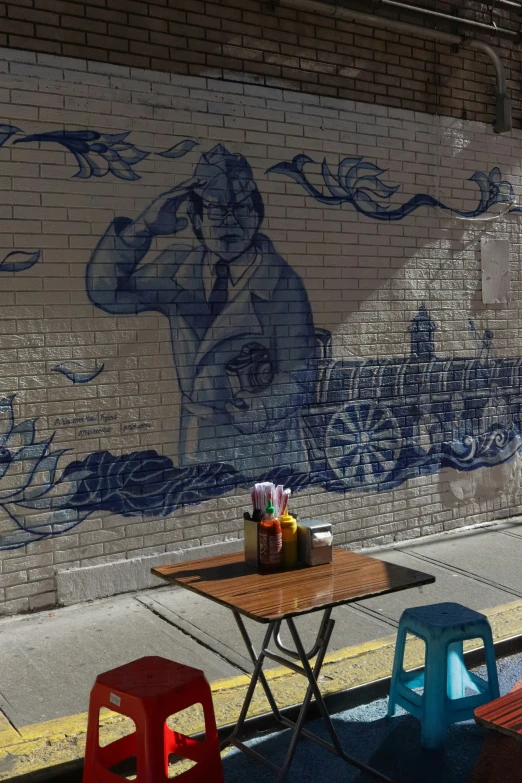 two benches next to a street with graffiti