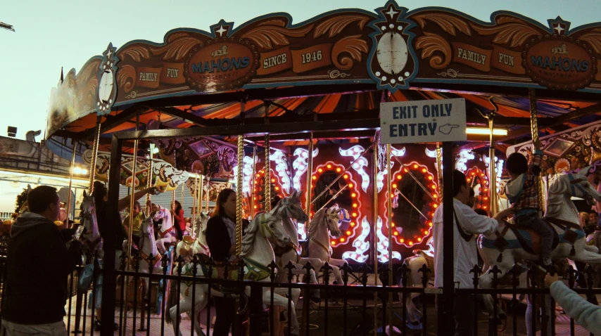 people walking around and in line at a carnival