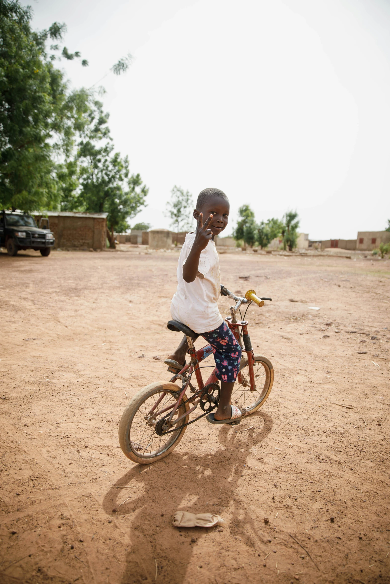 a person riding a small bicycle talking on the phone