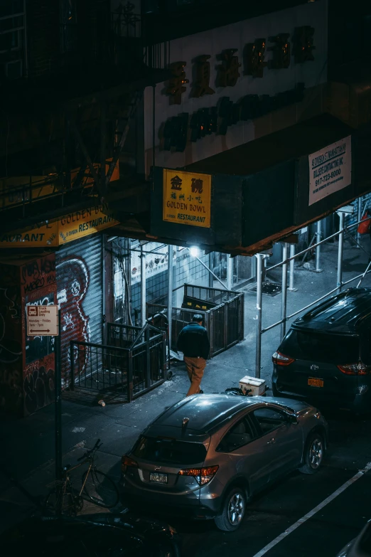 a group of cars are parked at a street side store