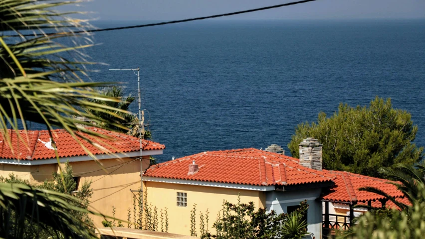 a couple of yellow buildings with red tiled roofs