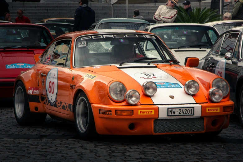 an orange and white car in a parking lot