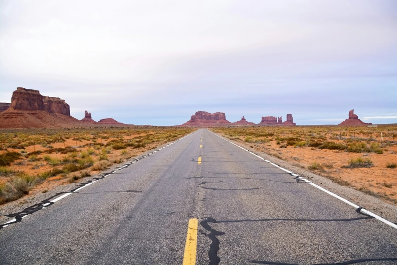 a deserted road with very little traffic signs on it