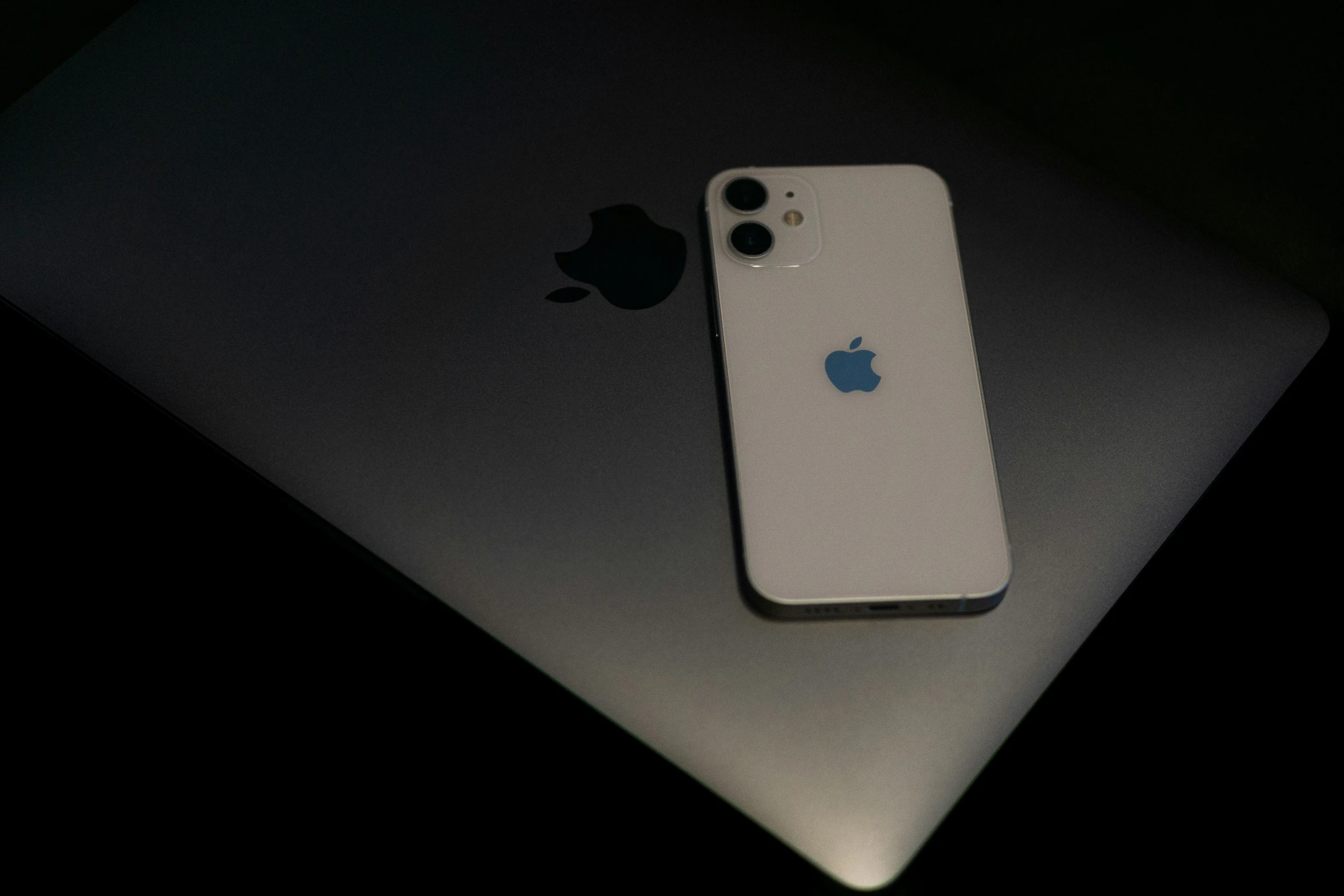 an apple phone next to an apple logo