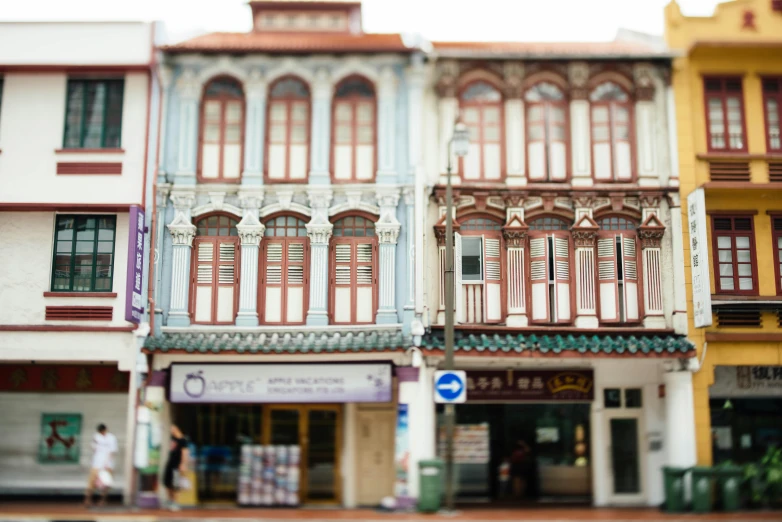 a few colorful buildings sitting along the side of a street