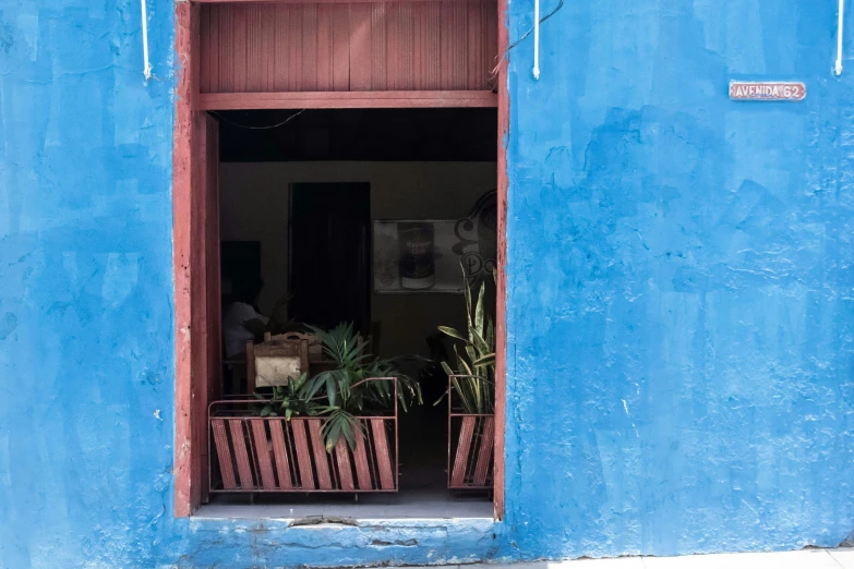 two wooden planters sit in the doorway of a building